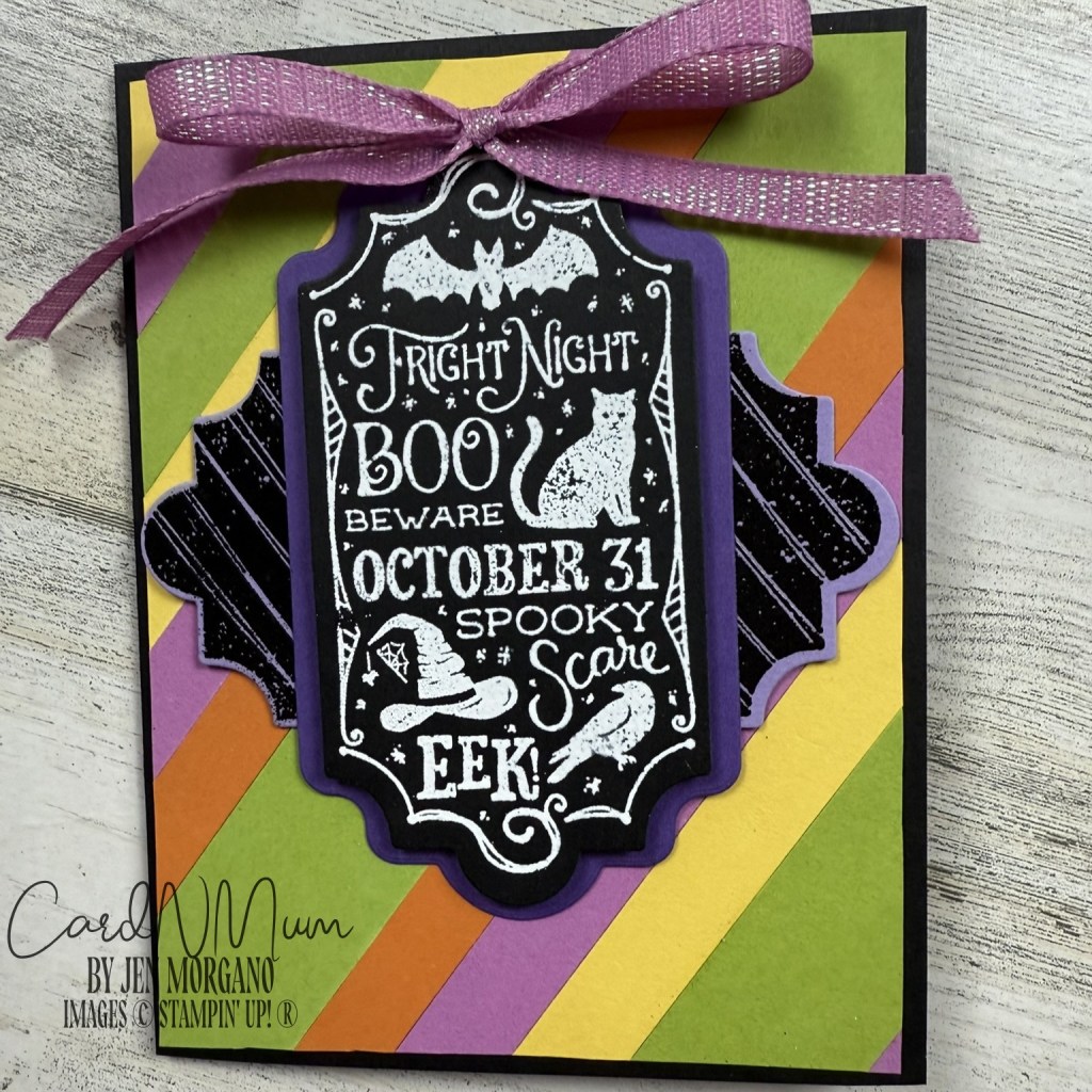 A colorful Halloween-themed card featuring spooky graphics like a black cat, a witch hat, and bats, with text that reads 'Fright Night Boo Beware October 31 Spooky Scare EEK!' adorned with a purple ribbon.