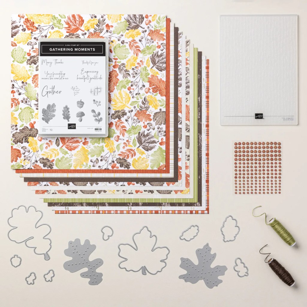 Flat lay featuring the Gathering Moments bundle, including colorful patterned paper, a stamp set with leaf designs, dies in leaf shapes, adhesive dots, and tools for crafting.