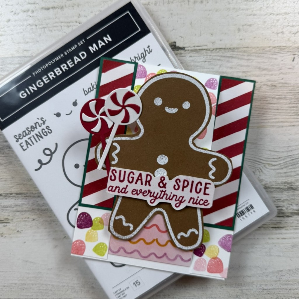 A festive card featuring a gingerbread man with the phrase 'SUGAR & SPICE and everything nice,' surrounded by candy and a peppermint stick.