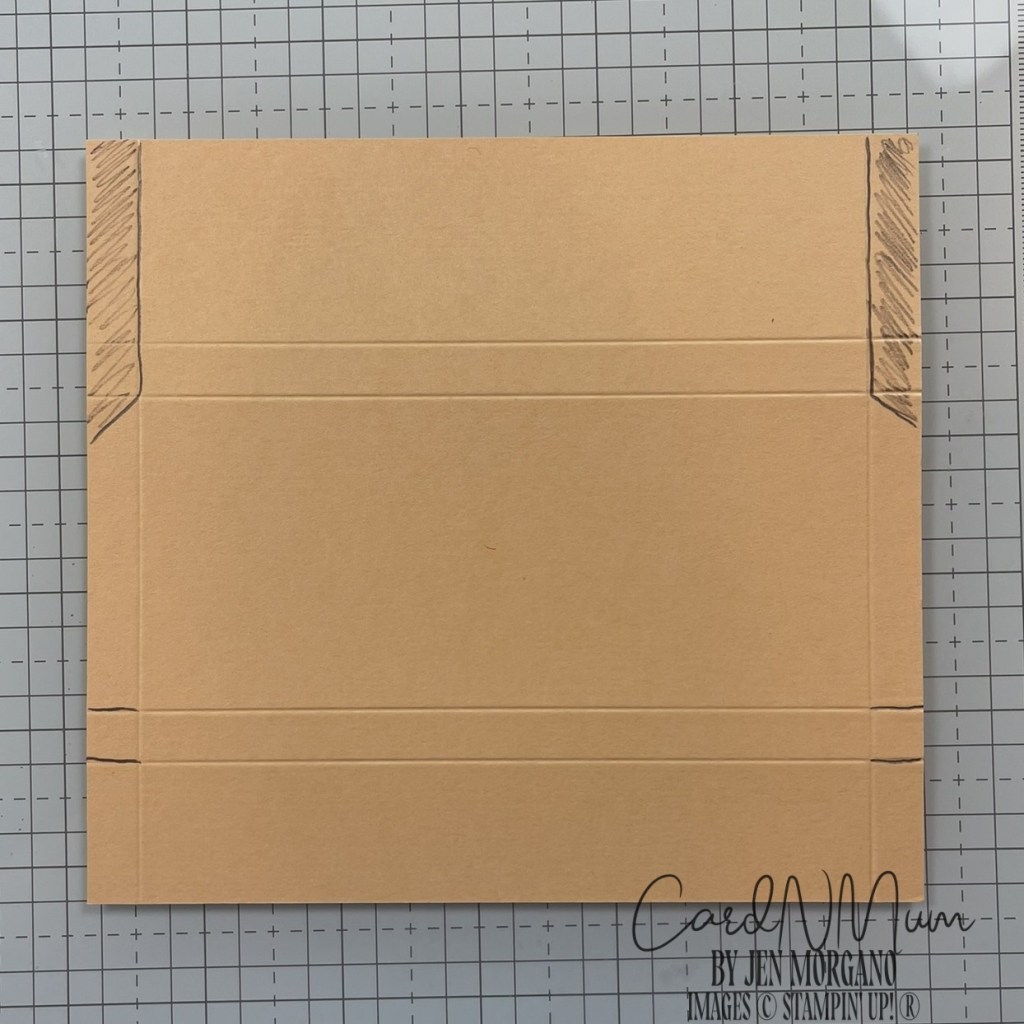 A cut and scored piece of brown cardstock, showing guide lines for creating a holder for a full-size Hershey bar.