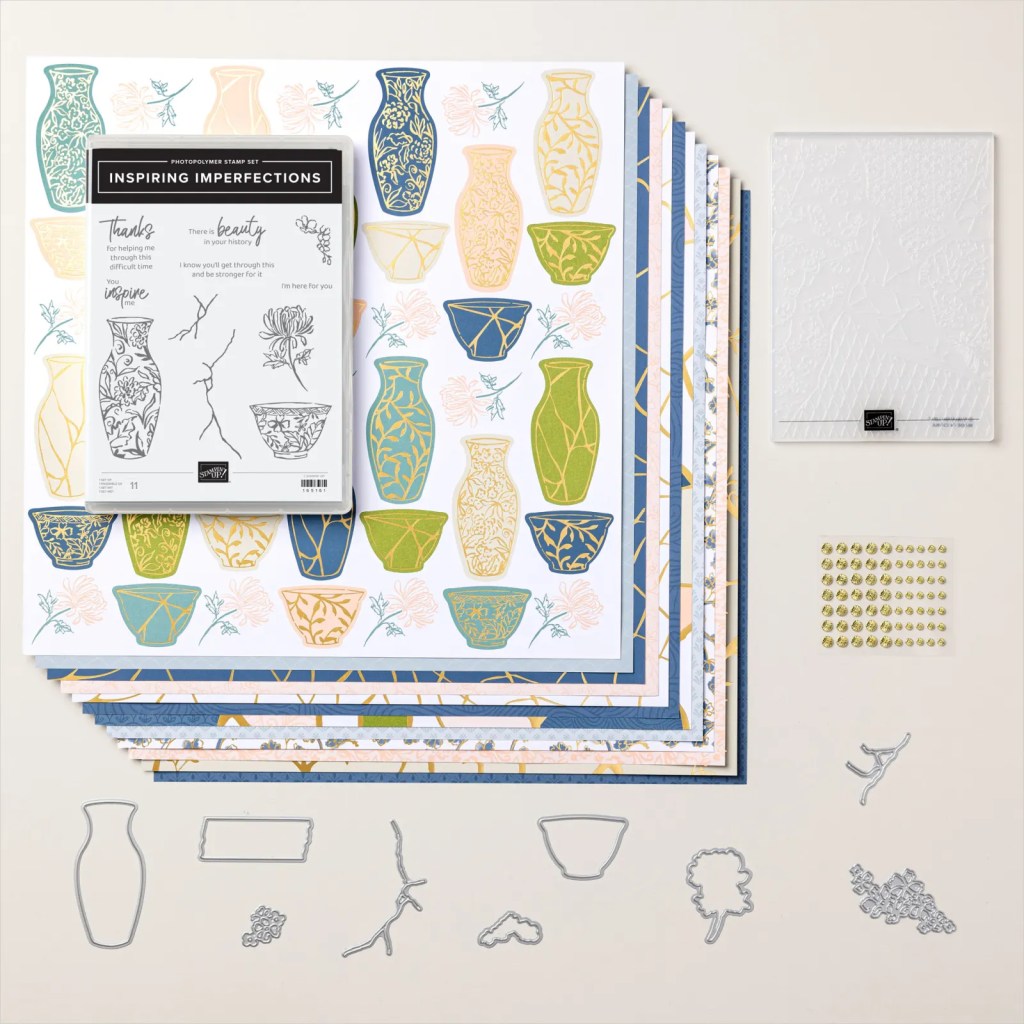 Flat lay of the Kintsugi Inspiration Suite Collection, featuring a photopolymer stamp set, patterned papers with vase designs, coordinating layers, an embossed card stock, and various metal die cuts, all showcasing elements inspired by the Japanese art of Kintsugi.