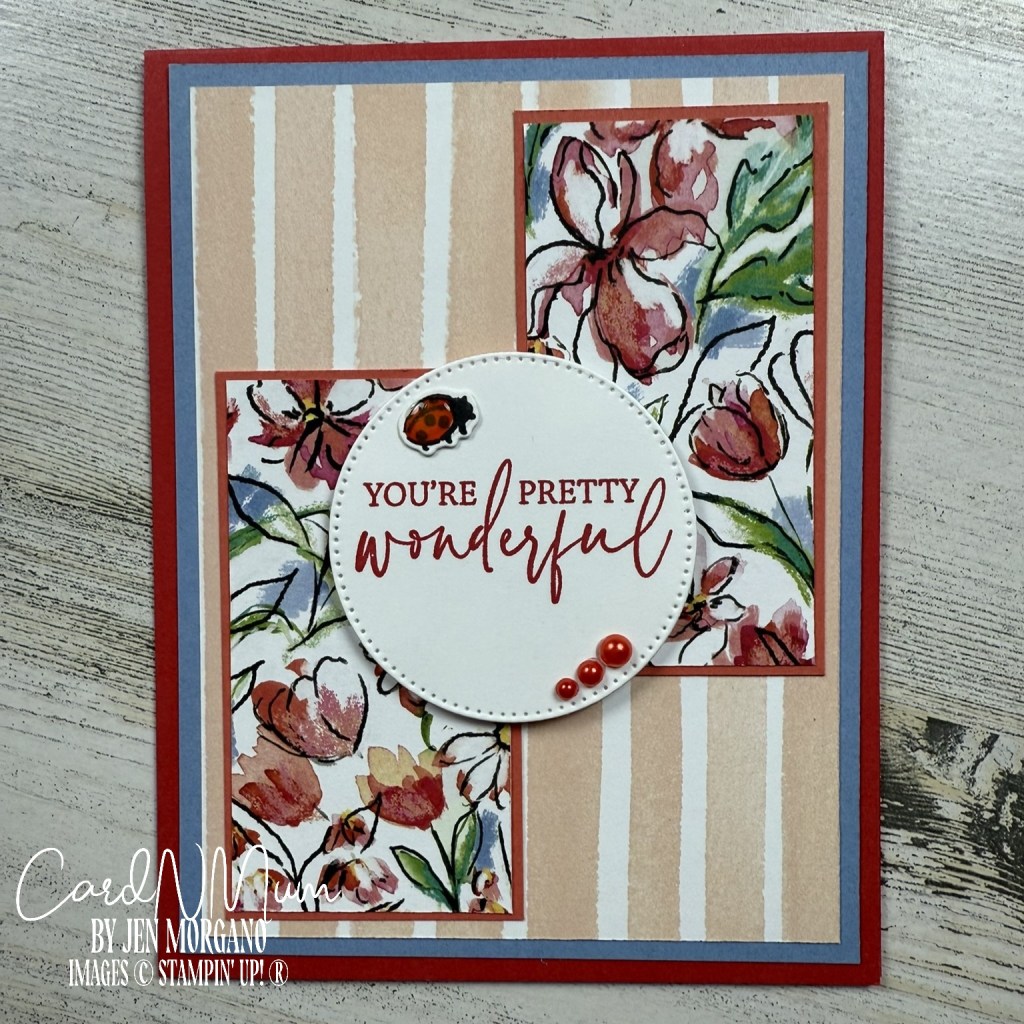 A handmade card featuring floral patterns in the background and a circular sentiment that reads 'YOU'RE PRETTY WONDERFUL' with a ladybug embellishment and red pearls.