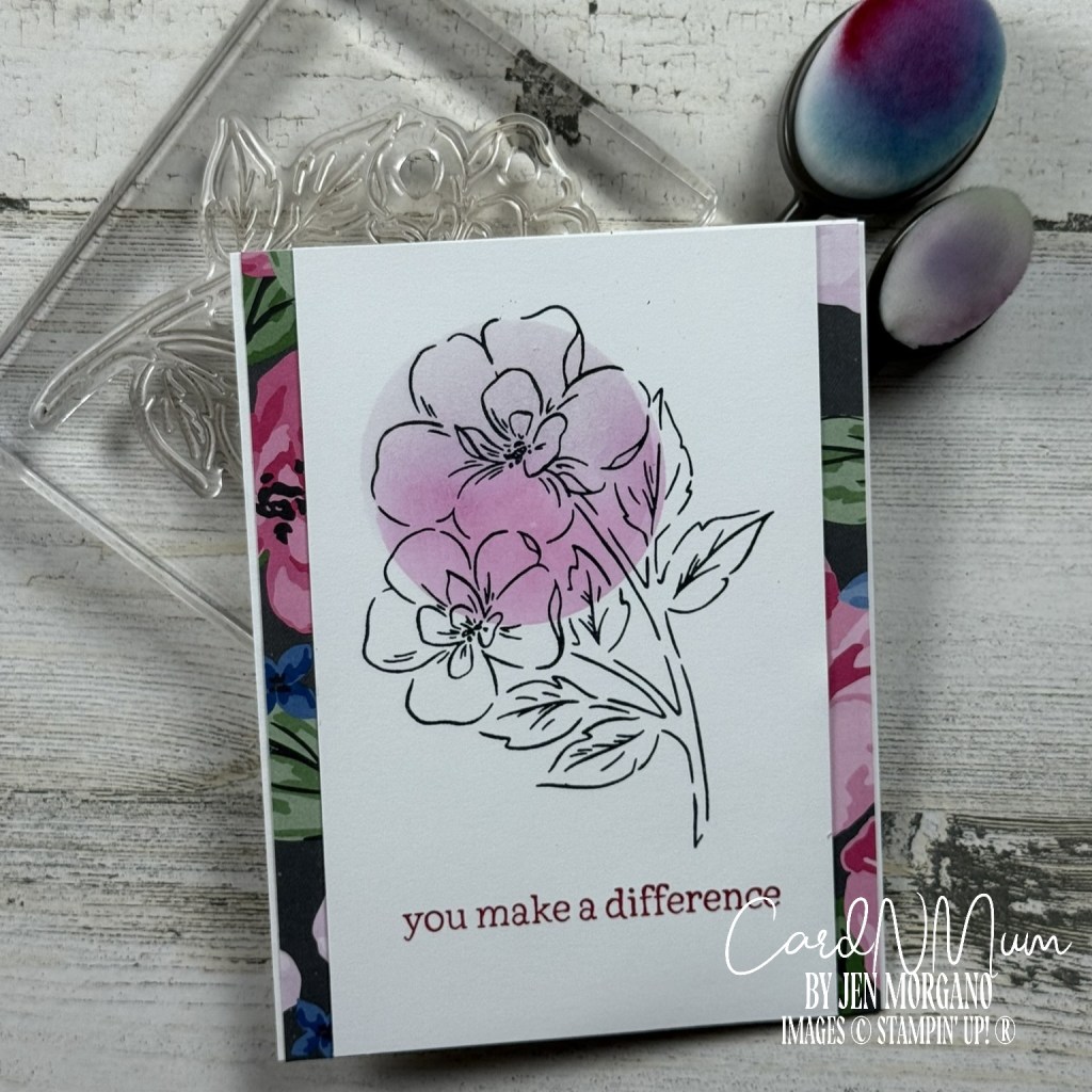A handmade greeting card featuring an outline of flowers with a watercolor effect in pink, accompanied by the text 'you make a difference' at the bottom.
