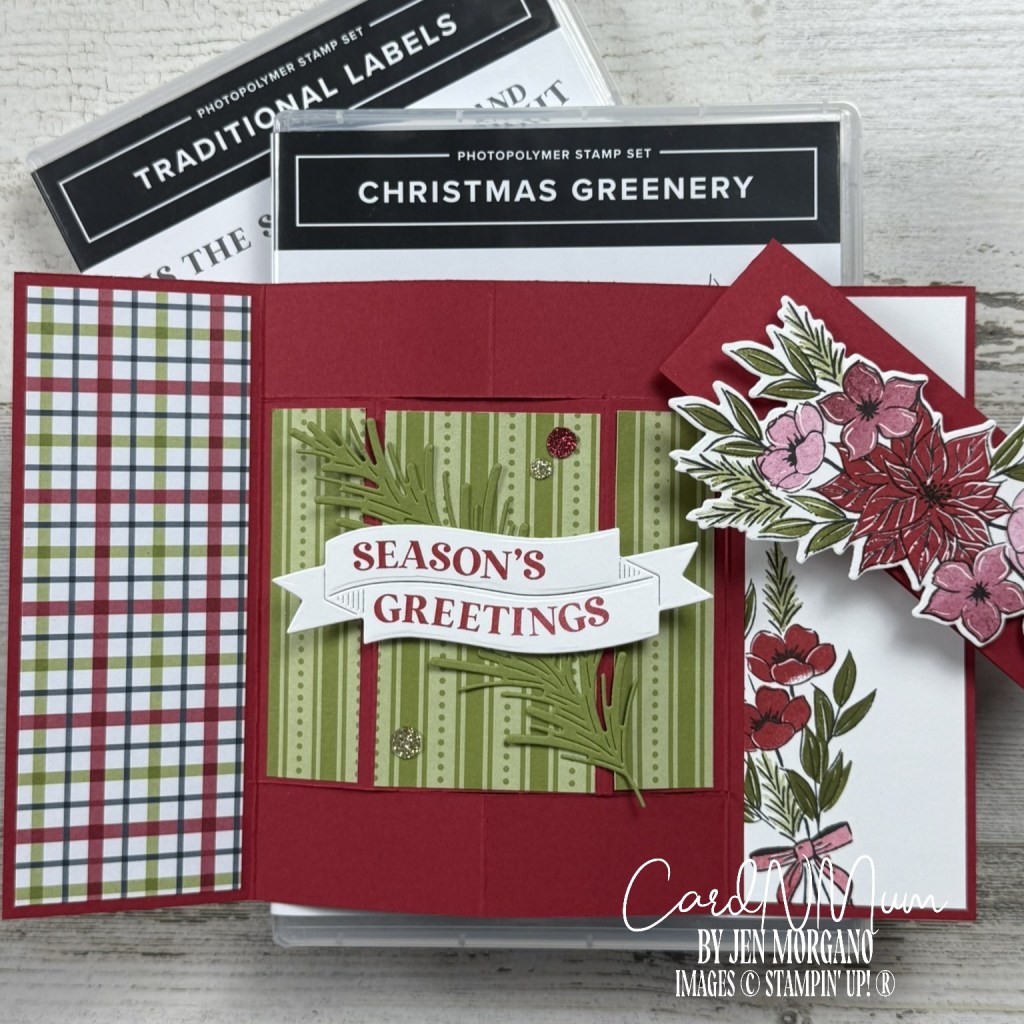 A handmade holiday card featuring a 'Season's Greetings' banner, decorated with green foliage and flowers on a red and plaid background, alongside stamp sets labeled 'Traditional Labels' and 'Christmas Greenery'.