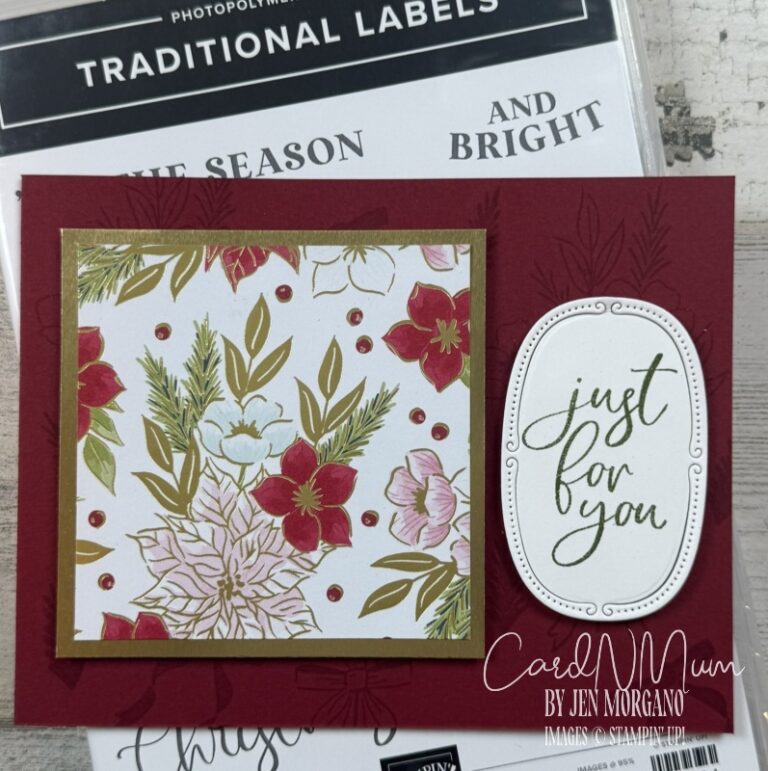 A handmade card with a red background featuring a decorative floral panel in gold, red, and green, along with an embossed oval label that says 'just for you.'