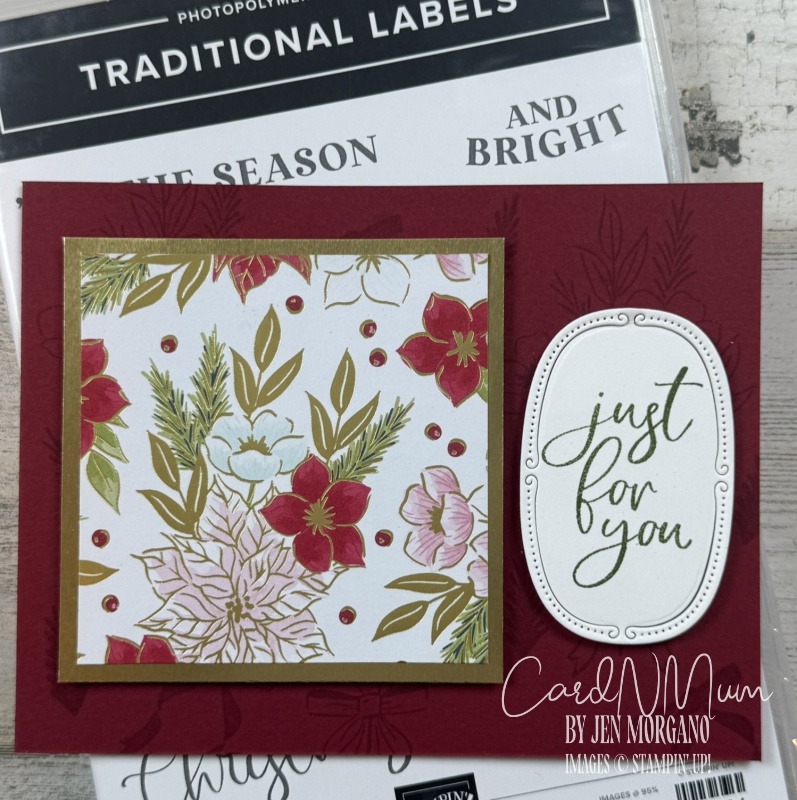 A handmade card with a red background featuring a decorative floral panel in gold, red, and green, along with an embossed oval label that says 'just for you.'