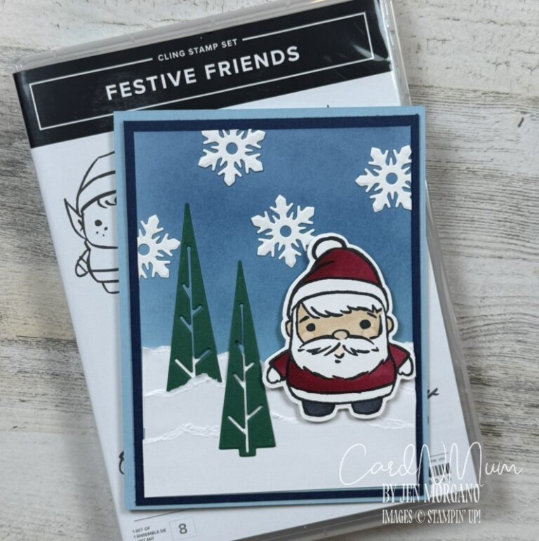 A festive card featuring a cartoon Santa Claus in a red outfit standing on a snowy landscape. There are green pine trees and snowflakes against a blue background. The card is accompanied by a packaging of a cling stamp set titled 'Festive Friends'.