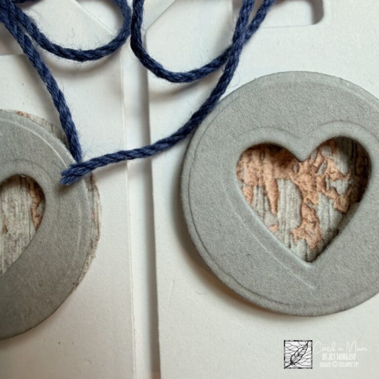 close up of handmade heart tag with twine bow and textured paper detail